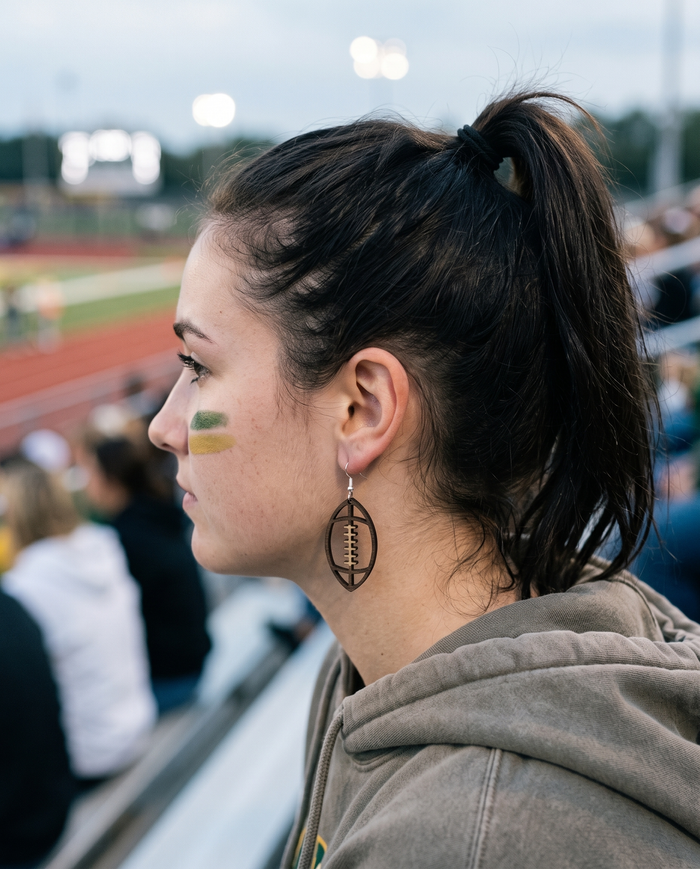 Footballs Earrings #1340 shown on model