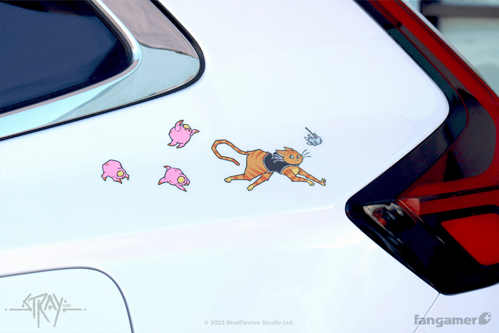Stray stickers photographed on the rear quarter panel of a white car, near the taillight. The large sticker of the cat running is placed in a scene with three zurks and B-12.