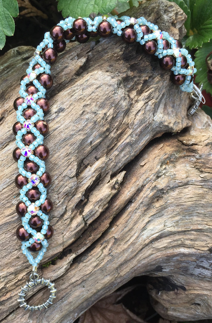 Pearl Montee bracelet includes chocolately brown glass pearls, pale aqua seed beads and Crystal Swarovski Montees and measures 7 1/2". The clasp is a seahorse!