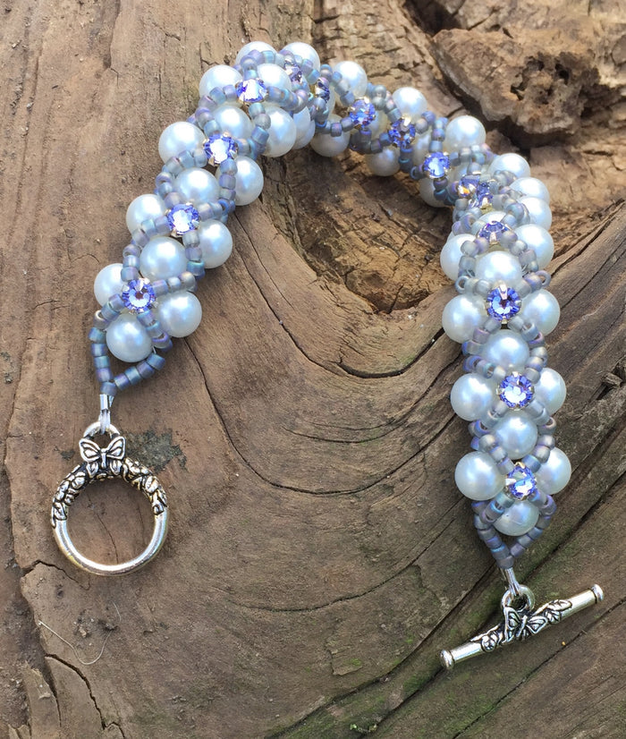 This White Glass Pearl bracelet comprises Matte Gray AB seed beads and Swarovski Provence Lavender Montees. This Pearl Montee bracelet measures 8".