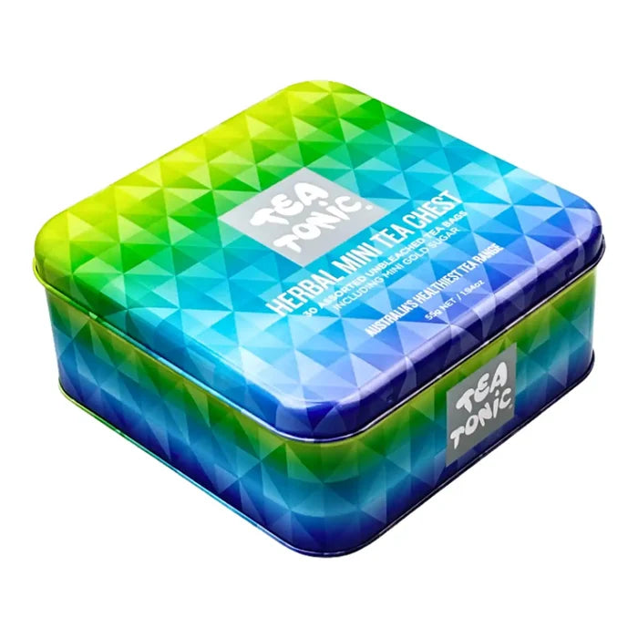 A square metal tea gift box featuring a vibrant geometric pattern that transitions from yellow and green to blue and purple.