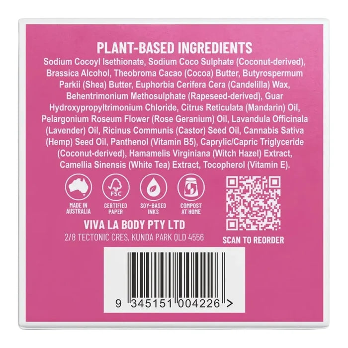 The back of a solid shampoo box, showing a list of ingredients, certification icons, QR code, and a barcode on a pink background.