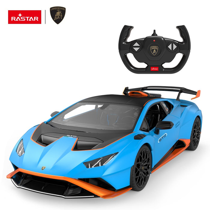 Rastar 1:14 Lamborghini Huracan STO RC car in sky blue with orange accents shown from front 3/4 angle alongside the Lamborghini-branded steering wheel remote controller. The car's aggressive wide-body aerodynamics, carbon-look hood, STO badging on the door, and large rear wing are clearly visible.