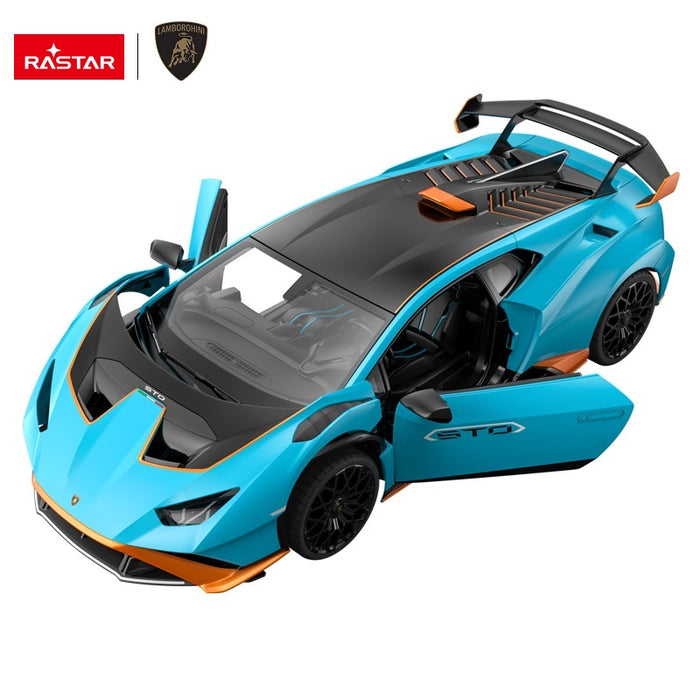 Rastar 1:14 Lamborghini Huracan STO RC car in sky blue with orange accents viewed from an overhead front 3/4 angle with both doors open. The carbon-look hood scoop, interior detail, wide rear wing with orange accent, and STO door graphics are prominently shown.